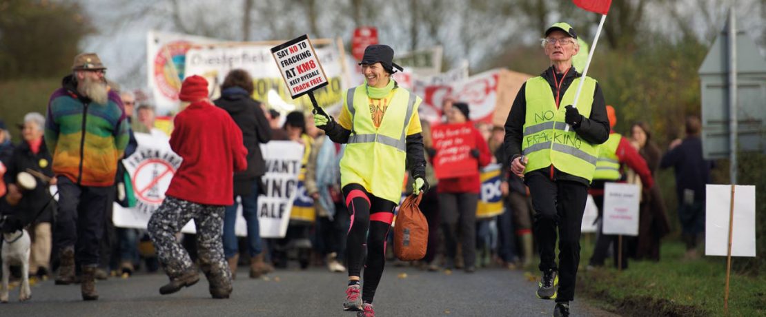 Fracking protestors marching with banners