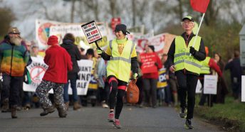 Fracking protestors marching with banners