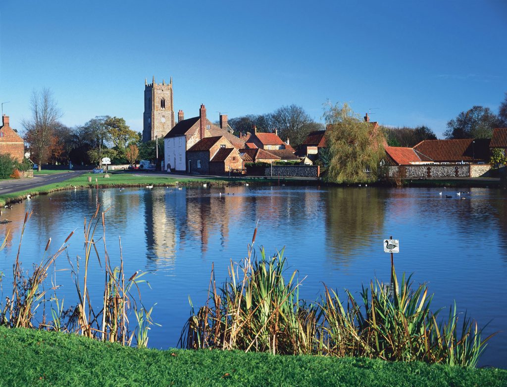 Great Massingham - a village in Norfolk, showing the church and pond