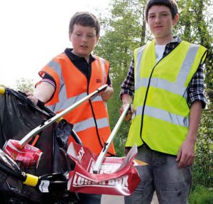 Two boys using CPRE equipment for a litter pick