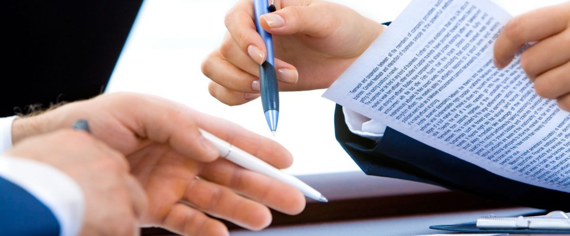 A close-up of hands holding a document
