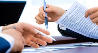 A close-up of hands holding a document