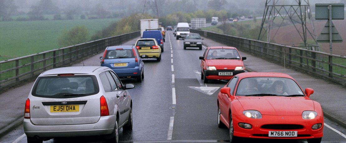 A single carriageway road busy with traffic