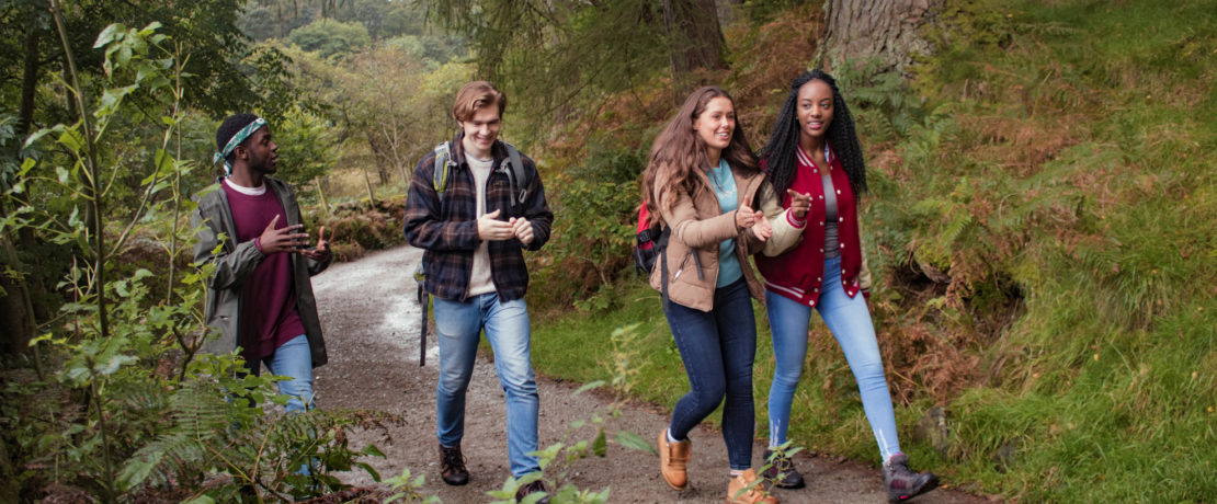 Young adults walking in woodland