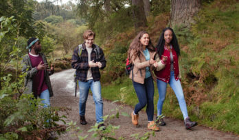 Young adults walking in woodland