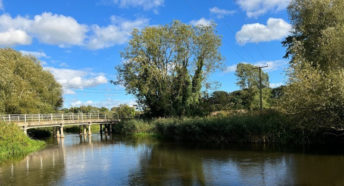 A view of the Wensum valley showing a bridge over a river