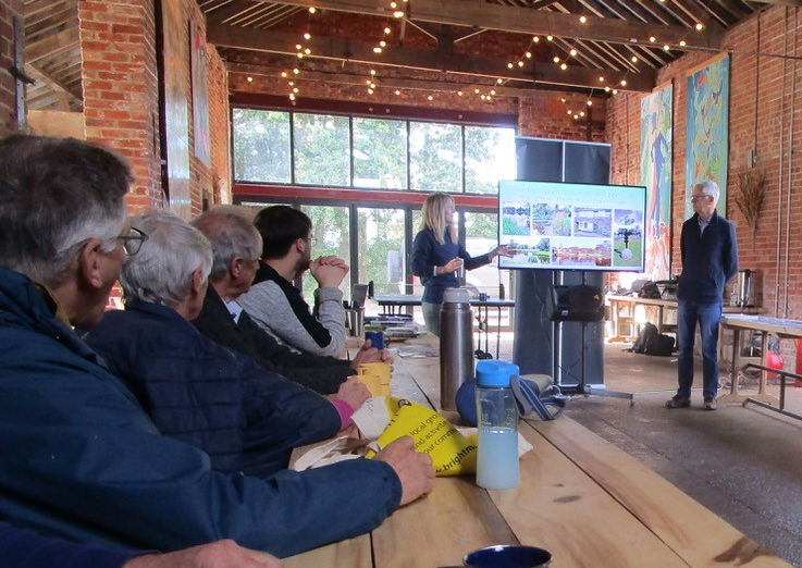 Laura Hampton pointing to a display screen during her presentation