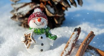 A snowman holding a present