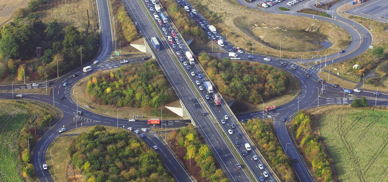 Busy traffic on a duel carriageway over a roundabout junction.