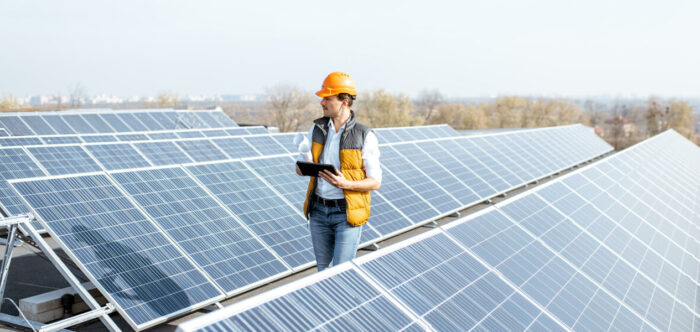 Man inspecting rooftop solar panels