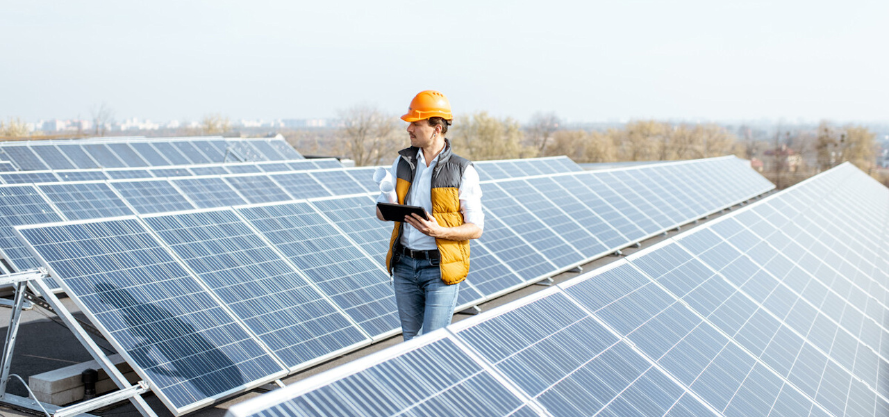 Man inspecting rooftop solar panels