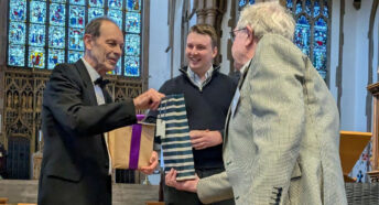 Retiring Chair, Chris Dady, receiving a presentation from George Ridgway with the new Chair, Elliot Griffiths looking on.