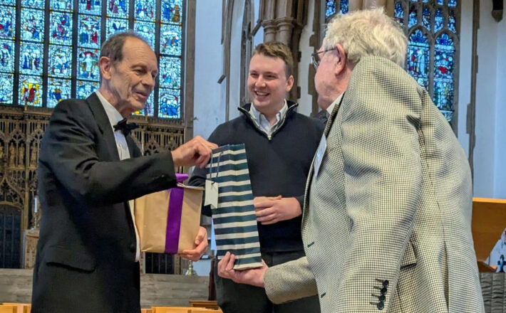 Retiring Chair, Chris Dady, receiving a presentation from George Ridgway with the new Chair, Elliot Griffiths looking on.