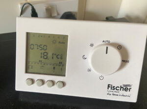 An individual room thermostat and timer control