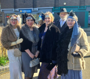 Five people dressed in 1926 costumes at the Diss museum opening.