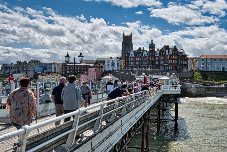 Families dropping crabbing lines off Cromer pier
