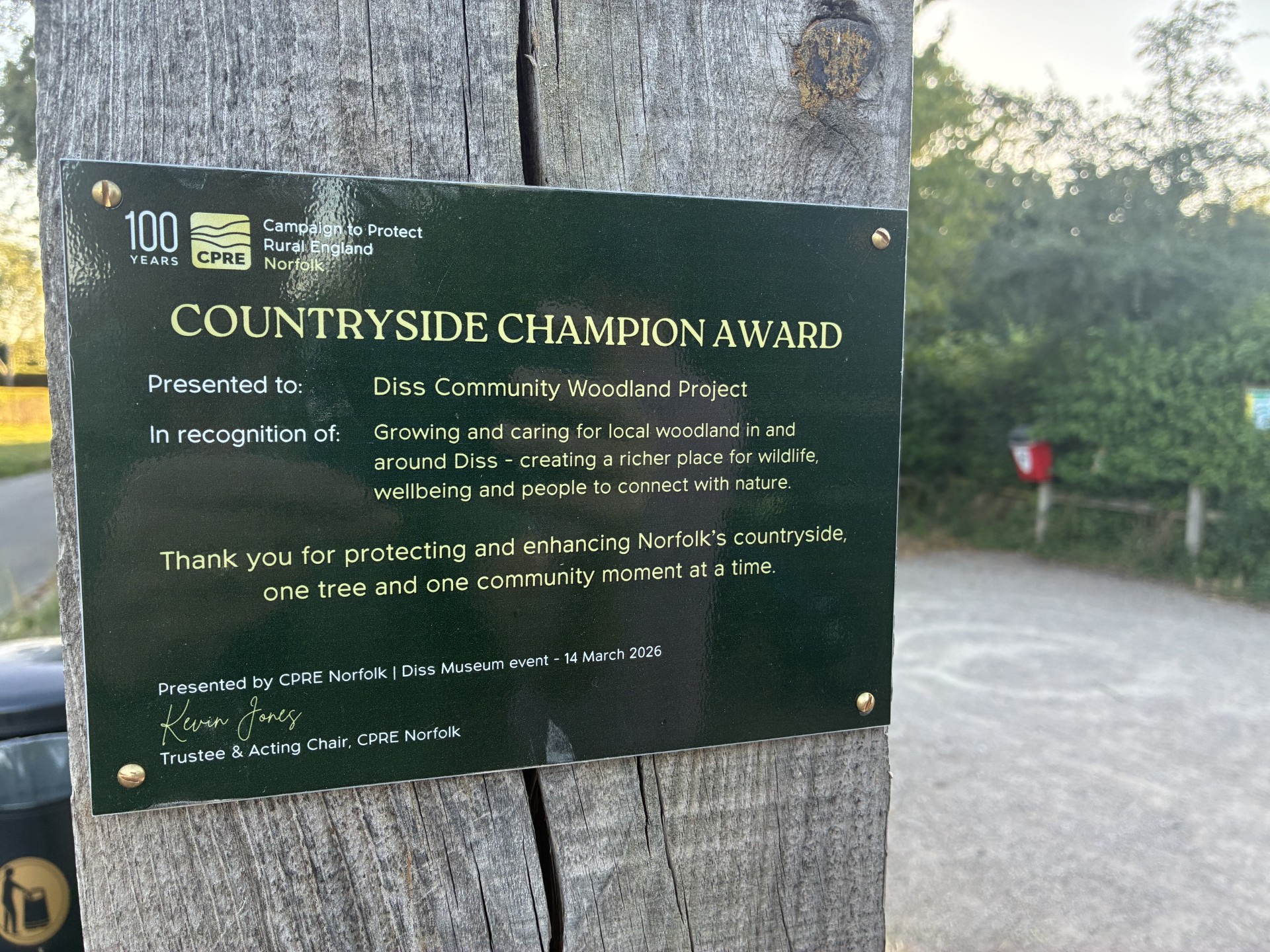 CPRE Norfolk's Countryside Champion Award plaque at the entrance to Quaker Wood, Diss