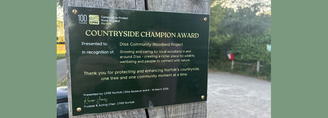 CPRE Norfolk's Countryside Champion Award plaque at the entrance to Quaker Wood, Diss